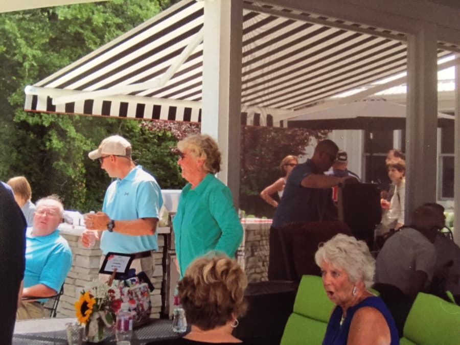 a group of people having a party outdoors under a retractable awning
